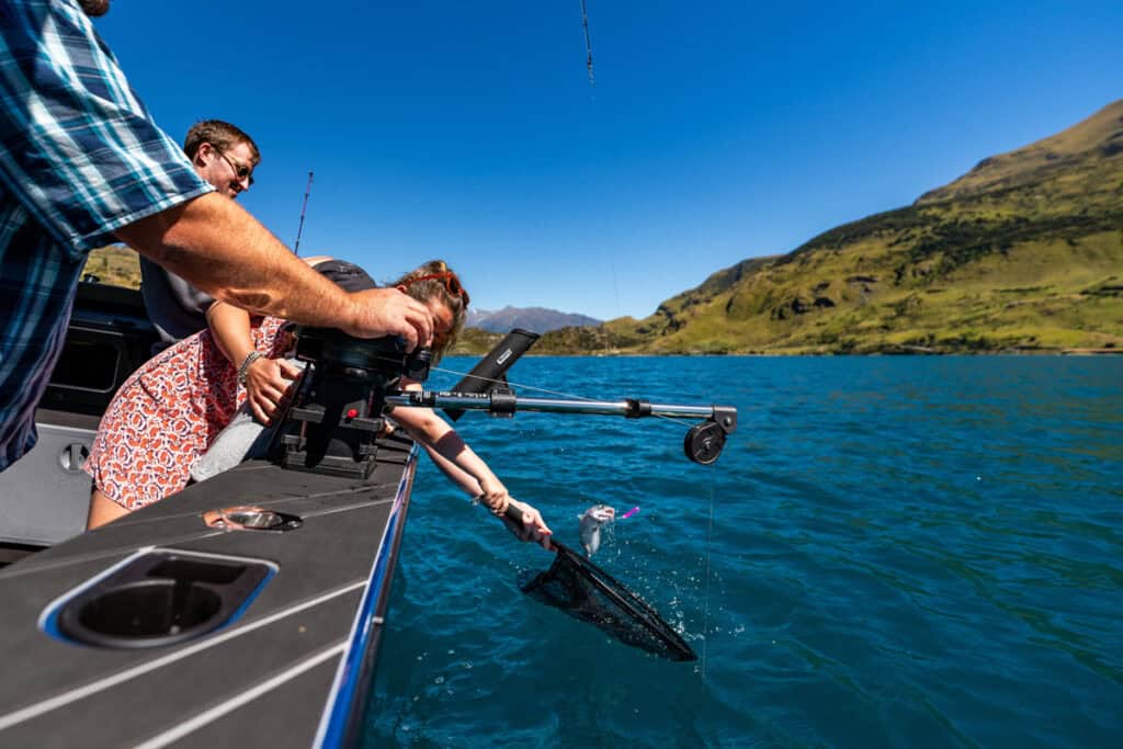 reeling-in-fish-ready-for-net-fishing-charter-nz