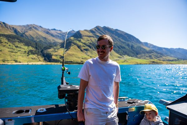 man-standing-ready-to-fish-boat-charter-nz Man standing on a fishing boat in New Zealand, ready to fish