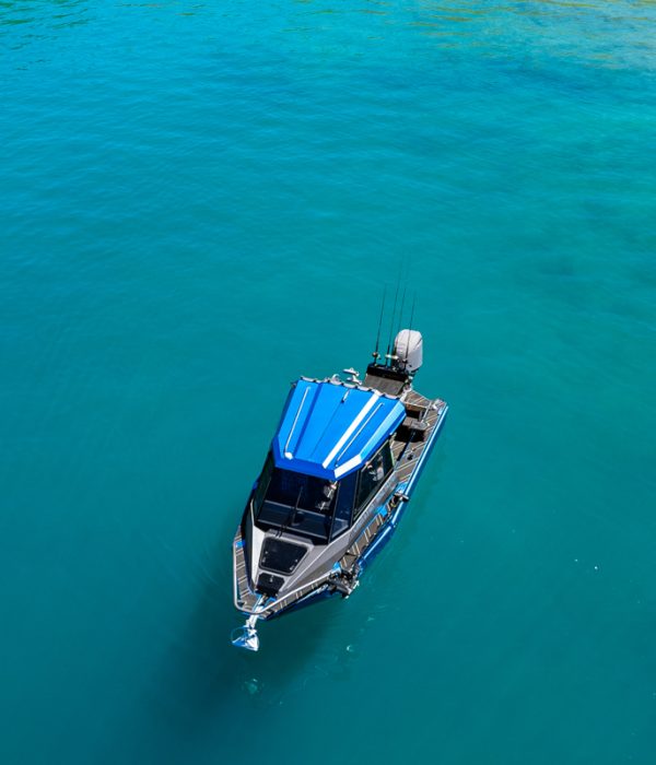top-view-boat-blue-water-bay-lake-hawea-nz Top-down view from fishing boat over clear blue water in a bay on Lake Hāwea