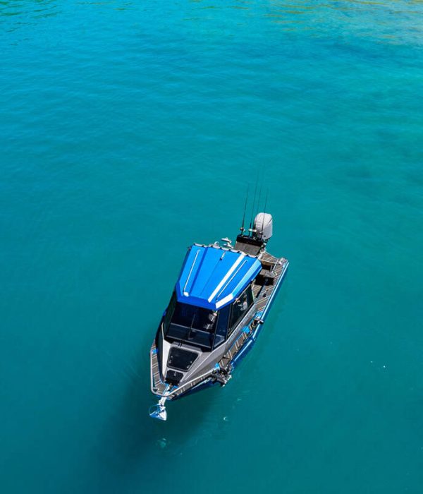 top-view-boat-blue-water-bay-lake-hawea-nz Top-down view from fishing boat over clear blue water in a bay on Lake Hāwea